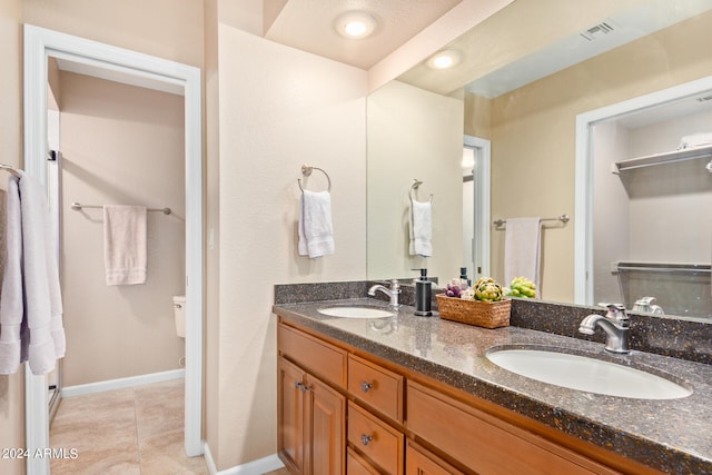 bathroom with tile patterned floors and vanity