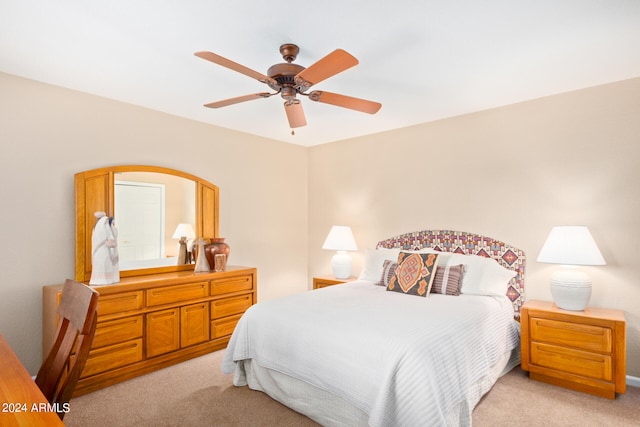 bedroom featuring light carpet and ceiling fan