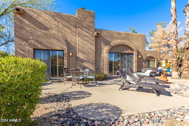 back of property with a patio