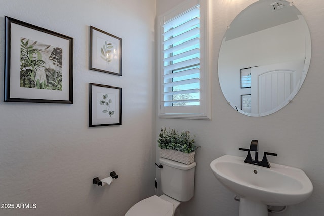 bathroom with toilet and sink