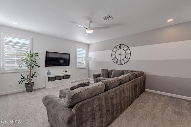 carpeted living room featuring ceiling fan