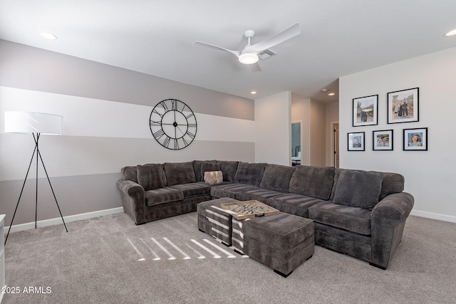 carpeted living room with ceiling fan