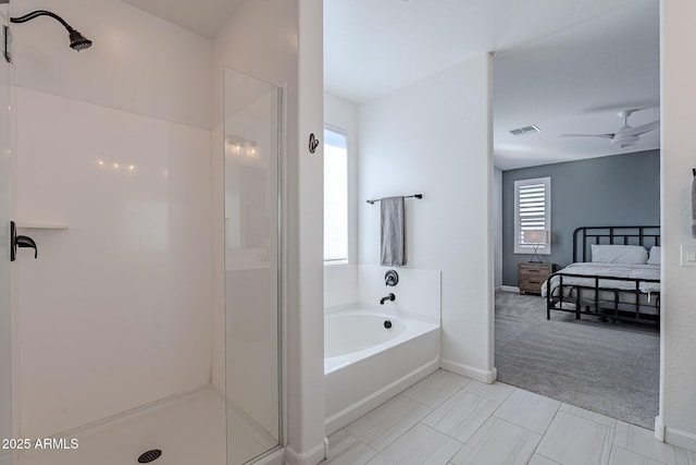 bathroom with separate shower and tub and ceiling fan