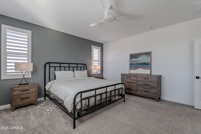 carpeted bedroom featuring multiple windows and ceiling fan