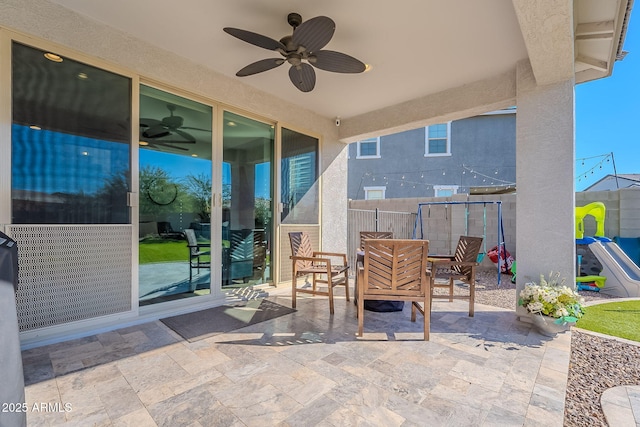 view of patio / terrace with a playground and ceiling fan