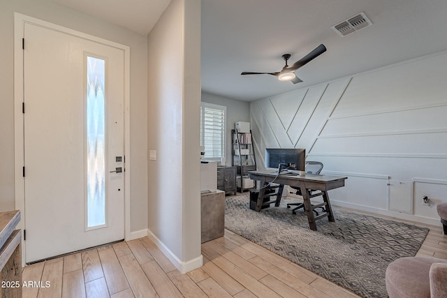 office space featuring ceiling fan and light wood-type flooring