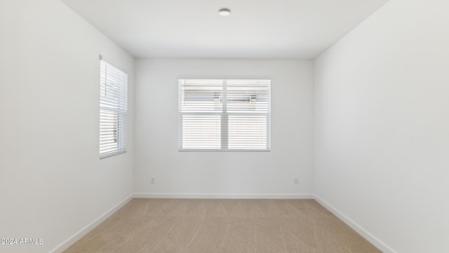 7327 W Buckhorn Trl, Peoria, AZ 85383 - unfurnished room with plenty of natural light, baseboards, and light carpet