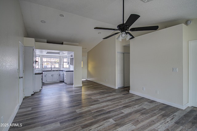 unfurnished living room featuring ceiling fan, wood-type flooring, a textured ceiling, and high vaulted ceiling