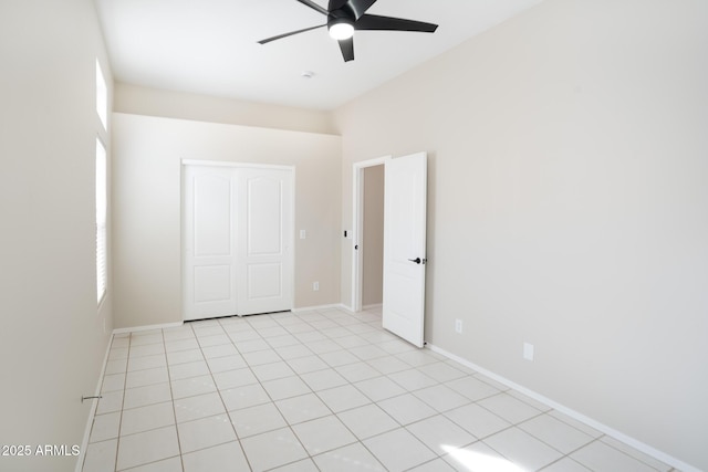 unfurnished room with light tile patterned flooring, a healthy amount of sunlight, and ceiling fan