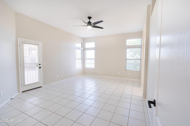 tiled empty room with ceiling fan