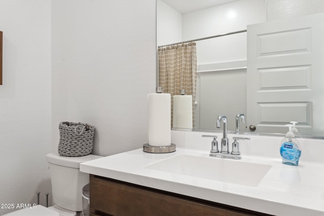 bathroom with vanity, toilet, and walk in shower