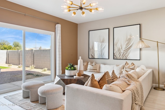 living room featuring a notable chandelier and light hardwood / wood-style floors