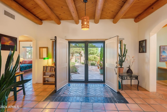 foyer entrance featuring tile patterned flooring, beam ceiling, and wooden ceiling