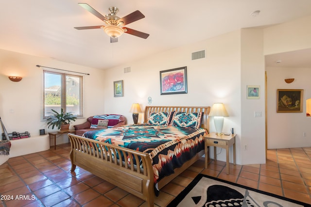 bedroom with ceiling fan and tile patterned flooring