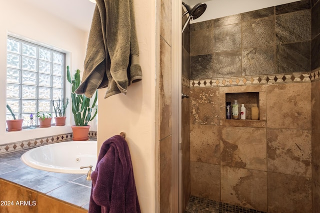 bathroom featuring shower with separate bathtub