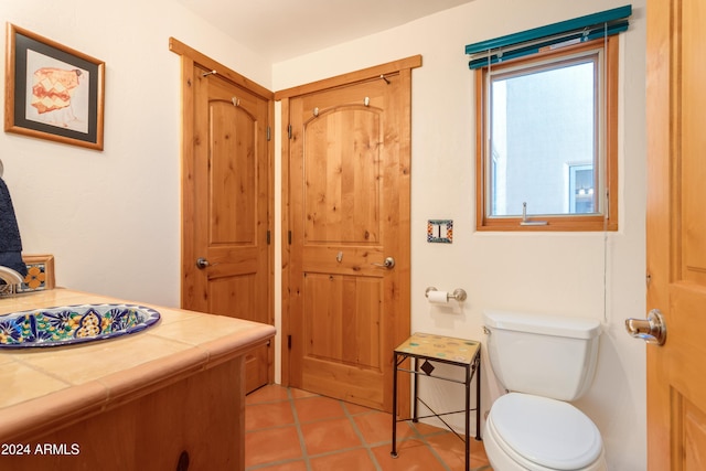 bathroom with tile patterned flooring, vanity, and toilet