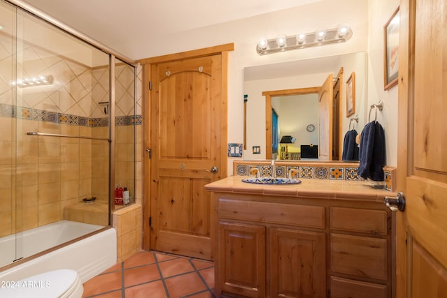 full bathroom with vanity, tile patterned flooring, toilet, and combined bath / shower with glass door