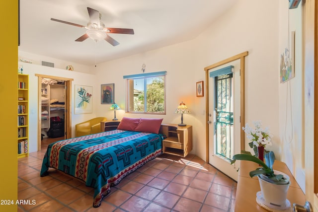 bedroom with a walk in closet, access to exterior, ceiling fan, tile patterned floors, and a closet