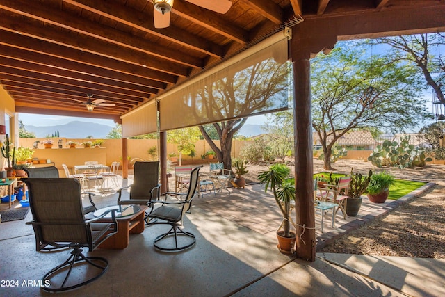 view of patio featuring a mountain view and ceiling fan