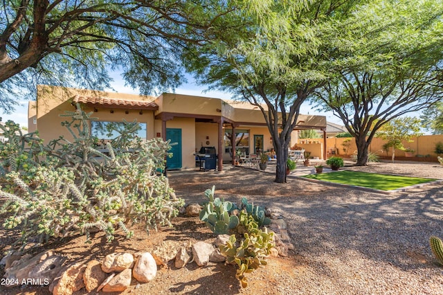 back of house with a patio