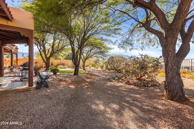 view of yard with a mountain view and a patio