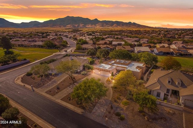 aerial view at dusk featuring a mountain view