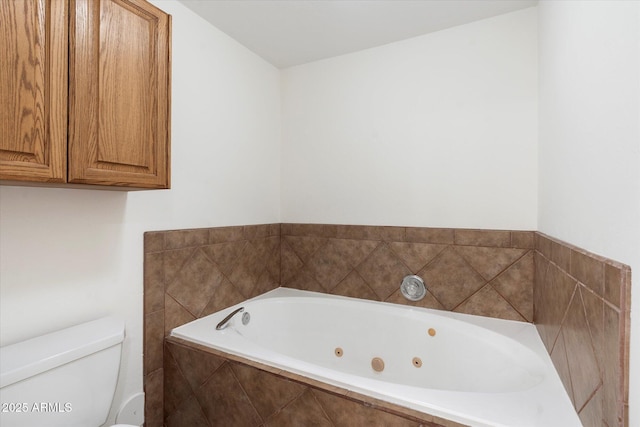 bathroom featuring toilet and a relaxing tiled tub