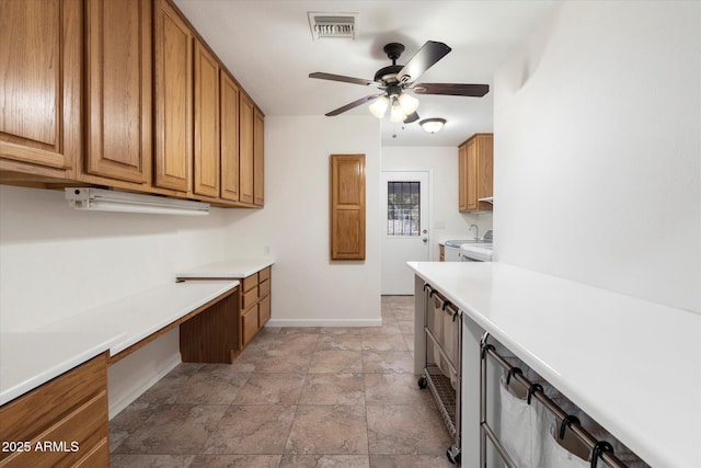 kitchen featuring ceiling fan, sink, and built in desk