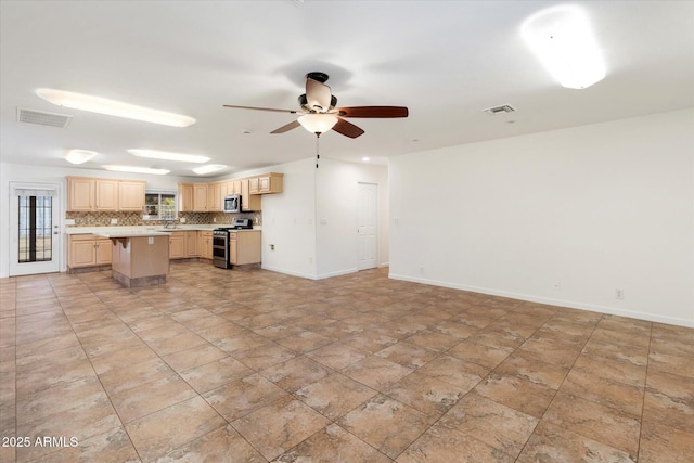 interior space with light brown cabinets, backsplash, a center island, a breakfast bar, and stainless steel appliances