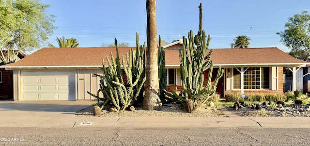 view of front of home with concrete driveway and a garage