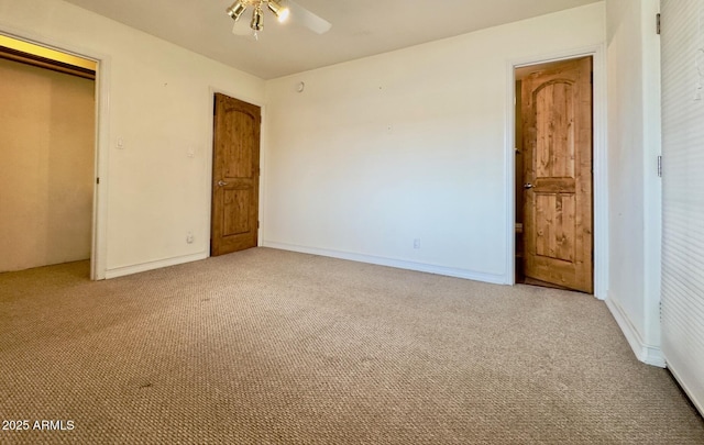 unfurnished bedroom with baseboards, light carpet, and a closet