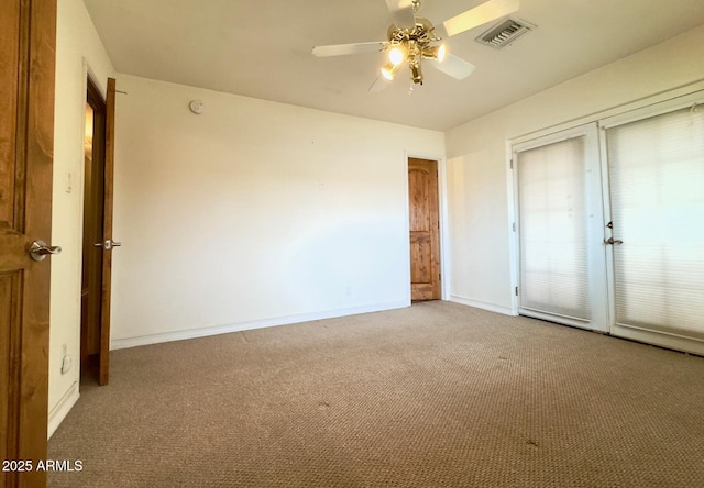 unfurnished bedroom with a closet, visible vents, carpet floors, and baseboards