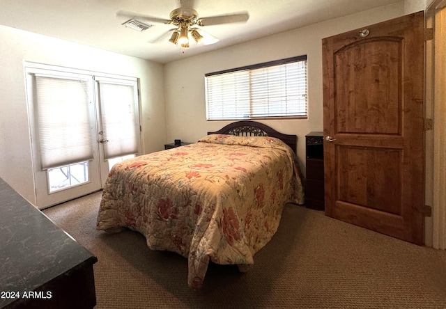 bedroom featuring french doors, dark carpet, and ceiling fan