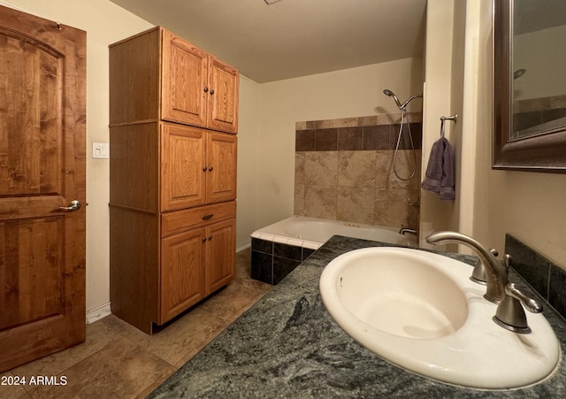 bathroom with tiled shower / bath combo, a sink, and tile patterned floors