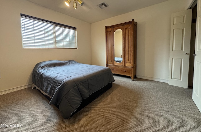 bedroom with carpet flooring, visible vents, and baseboards