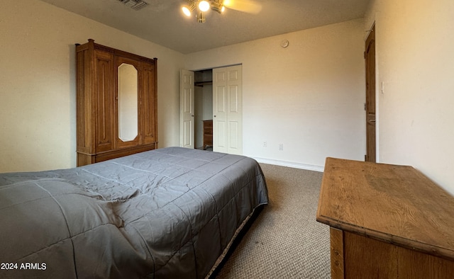 carpeted bedroom featuring ceiling fan and a closet