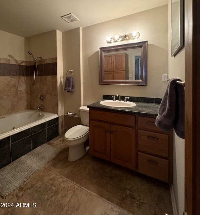 bathroom featuring tiled shower / bath combo, tile patterned floors, toilet, vanity, and visible vents