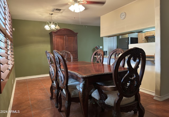 tiled dining area with ceiling fan with notable chandelier