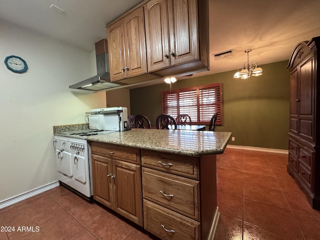 kitchen with dark tile patterned floors, a notable chandelier, pendant lighting, extractor fan, and white stove