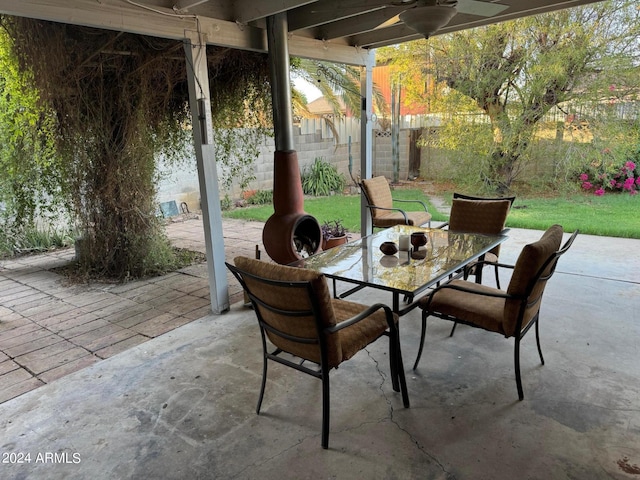 view of patio with outdoor dining area, a ceiling fan, and a fenced backyard
