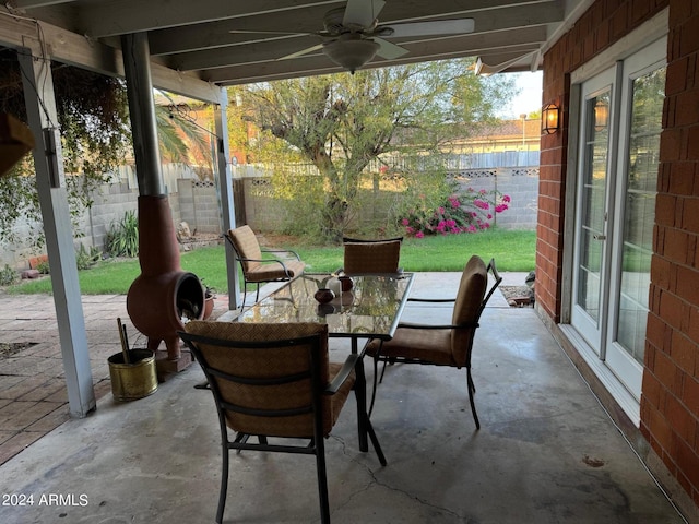 view of patio featuring outdoor dining area, ceiling fan, and a fenced backyard