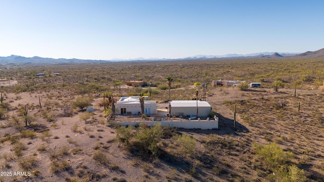 aerial view of sparsely populated area with a mountainous background and a desert landscape