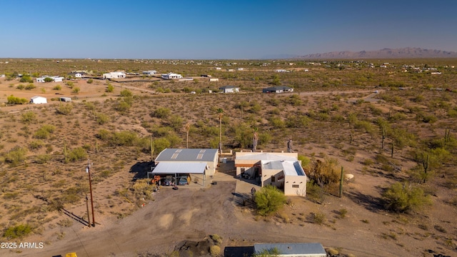 view of rural area with a desert landscape and a mountainous background