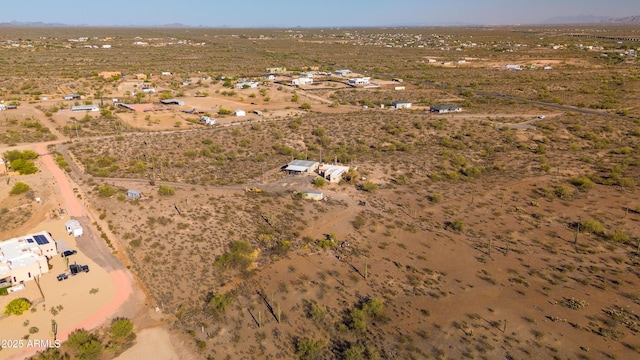 aerial overview of property's location with a desert landscape, rural landscape, and a mountainous background
