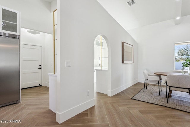 office space featuring high vaulted ceiling and light parquet flooring