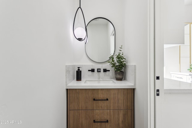 bathroom featuring vanity and backsplash