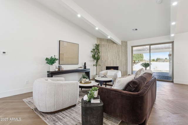 living room with a large fireplace, parquet floors, and beam ceiling