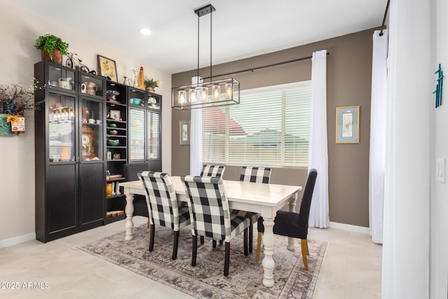 dining room with a notable chandelier and light tile patterned floors