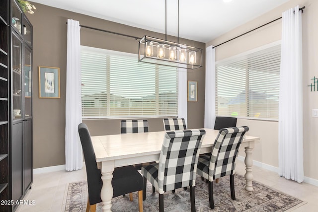 tiled dining space featuring a wealth of natural light