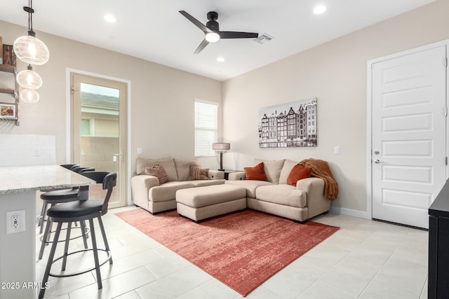 tiled living room featuring ceiling fan